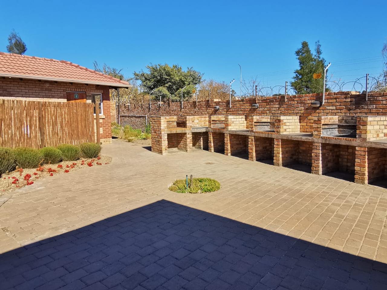 The communal braai courtyard, a row of built-in braais